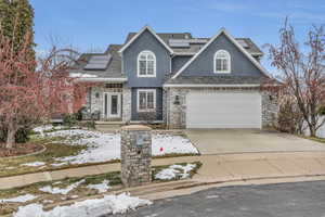 View of front of home featuring a garage and solar panels