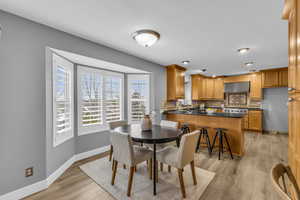 Dining space with light hardwood / wood-style flooring