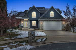 View of front of house with a garage and solar panels