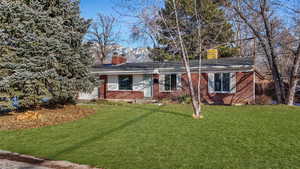 Ranch-style house featuring a front yard