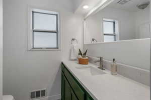 Bathroom featuring vanity and toilet