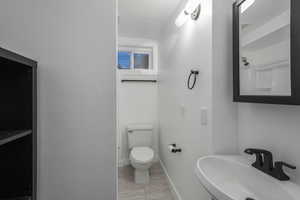 Bathroom featuring sink and toilet