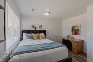 Bedroom with hardwood / wood-style flooring