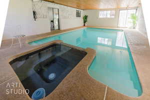 View of swimming pool with an in ground hot tub