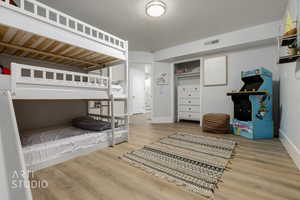 Bedroom with hardwood / wood-style flooring and a textured ceiling