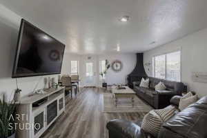 Living room with hardwood / wood-style flooring and a textured ceiling