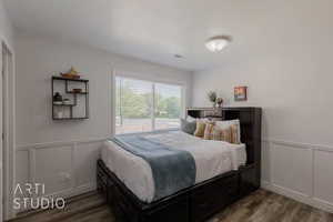 Bedroom with hardwood / wood-style flooring