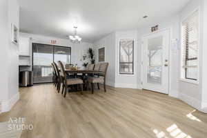 Dining space featuring an inviting chandelier and light hardwood / wood-style floors