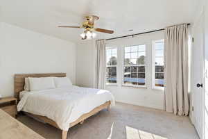 Carpeted bedroom with ceiling fan