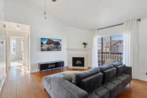 Living room featuring lofted ceiling and light hardwood / wood-style flooring