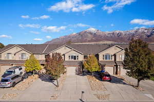 Front facade with a garage and a mountain view