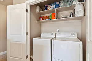 Washroom featuring independent washer and dryer and carpet flooring