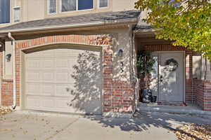 Doorway to property featuring a garage