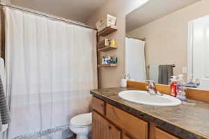 Bathroom featuring vanity and toilet