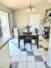 Dining area featuring an inviting chandelier and light tile patterned floors