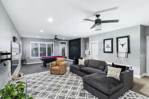 Living room with ceiling fan, pool table, and carpet flooring