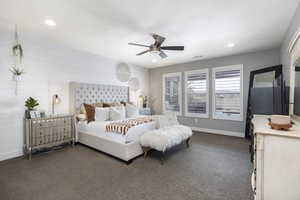 Bedroom with ceiling fan and dark carpet