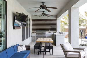 View of patio featuring a sink, a grill, area for grilling, ceiling fan, and an outdoor living space