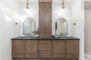 Full bath with a sink and double vanity