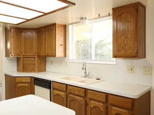 Kitchen featuring sink and white dishwasher