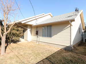 Back of house with a lawn