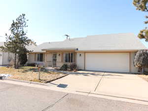 Ranch-style house with a garage and a porch