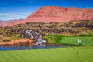 View of Golf Course with mountain feature featuring a water view