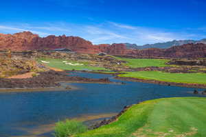 View of Golf Course with water feature and a mountain view