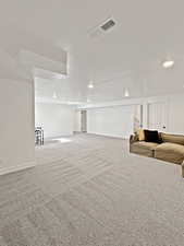 Basement featuring a textured ceiling and carpet