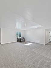 Interior space with carpet flooring and a textured ceiling