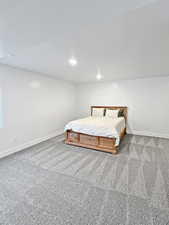 Carpeted bedroom featuring a textured ceiling