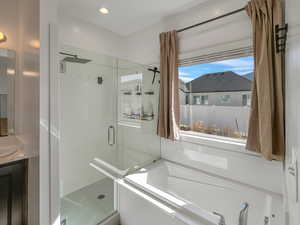 Bathroom featuring vanity and plus walk in shower