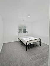 Bedroom featuring carpet flooring and a textured ceiling