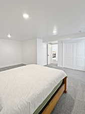 Bedroom with dark carpet and a closet