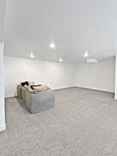 Unfurnished living room featuring light carpet and a textured ceiling