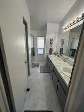 Bathroom featuring vanity, toilet, a textured ceiling, and walk in shower