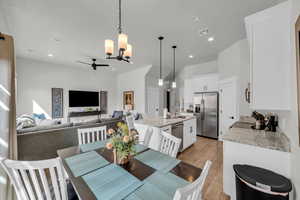 Dining room featuring sink, light hardwood / wood-style flooring, and ceiling fan