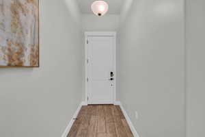 Doorway with hardwood / wood-style floors