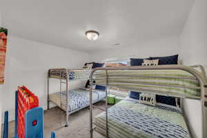 Carpeted bedroom with a textured ceiling