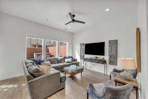 Living room featuring ceiling fan and light hardwood / wood-style flooring