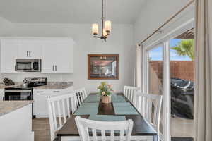 Tiled dining room with an inviting chandelier