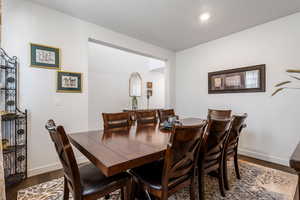 Dining space featuring dark hardwood / wood-style flooring and a textured ceiling