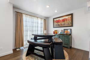 Dining space featuring dark wood-type flooring and a textured ceiling