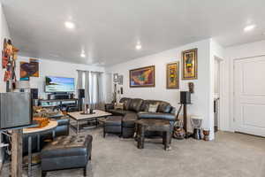 Carpeted living room with a textured ceiling