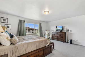 Carpeted bedroom with a textured ceiling