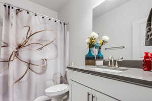 Bathroom featuring vanity and toilet