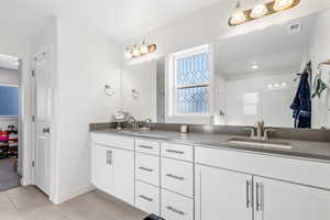 Bathroom featuring tile patterned flooring and vanity