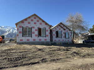 Property in mid-construction featuring a mountain view and a carport