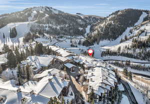 Snowy aerial view featuring a mountain view