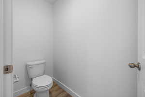 Bathroom with wood-type flooring and toilet